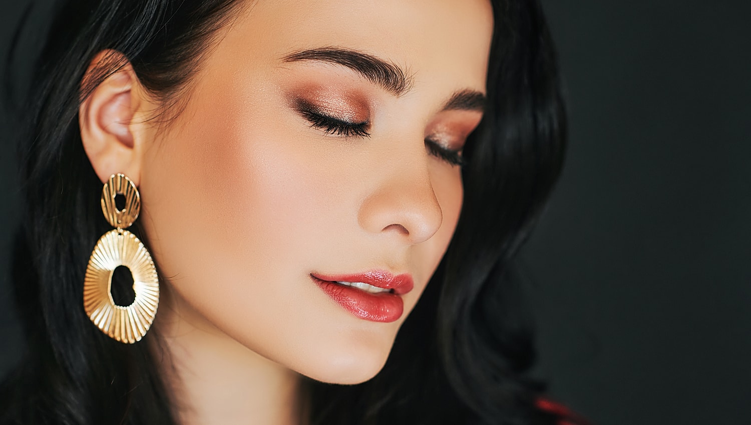 Close-up of a woman's face with earrings.