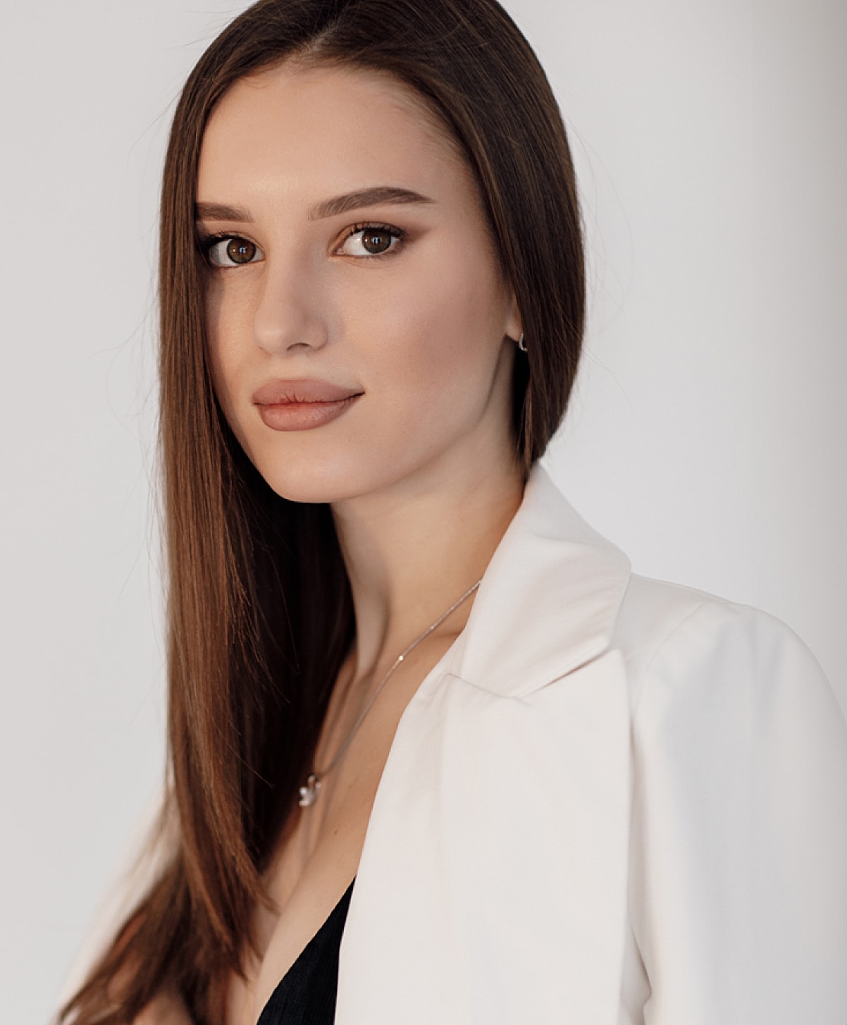 Woman with long hair in a stylish outfit.
