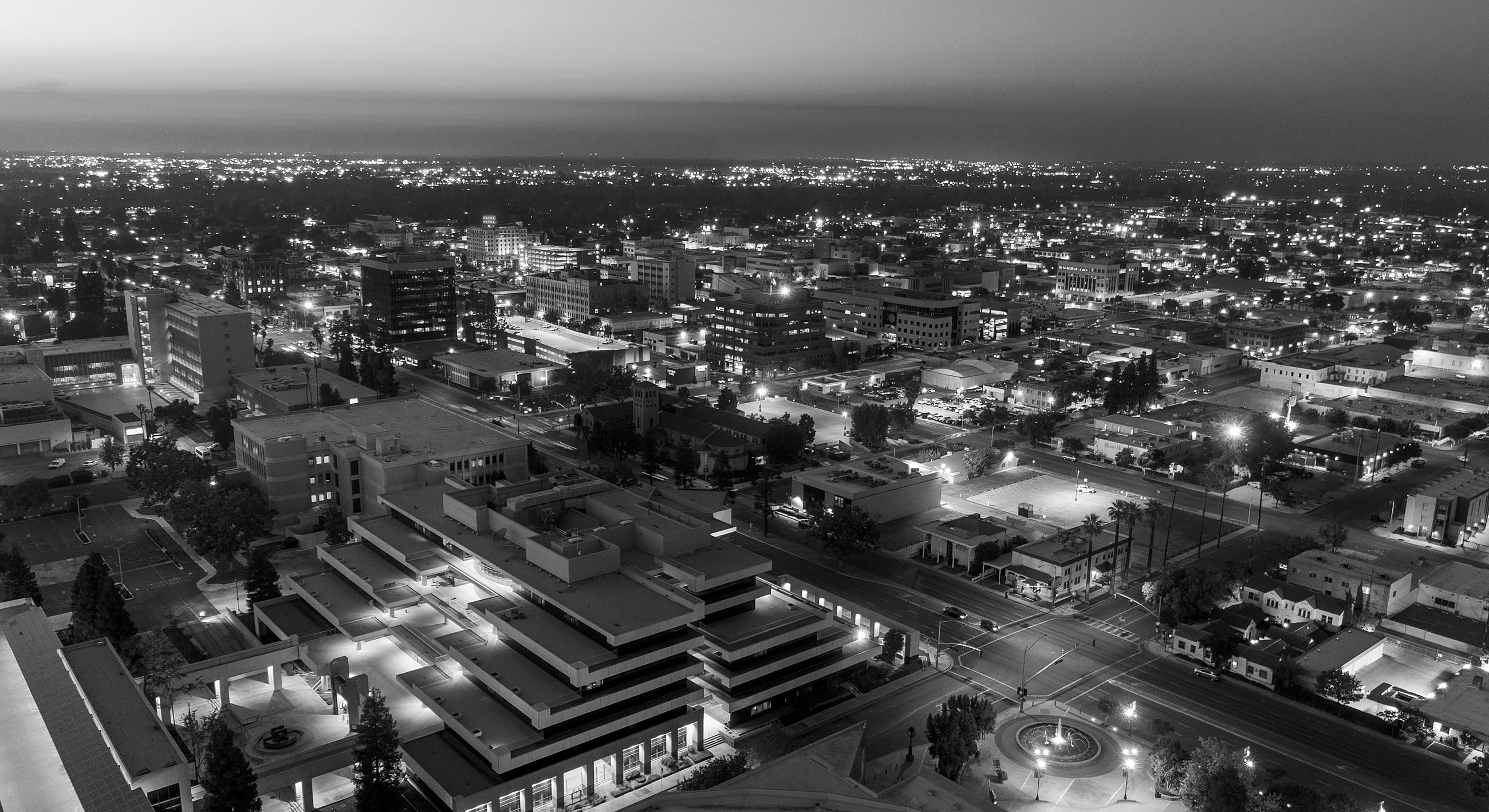 City skyline at night in black and white.